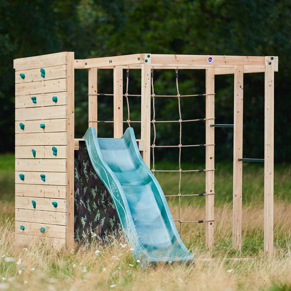 Plum Play's Wooden Climbing Cube in the middle of a lawn