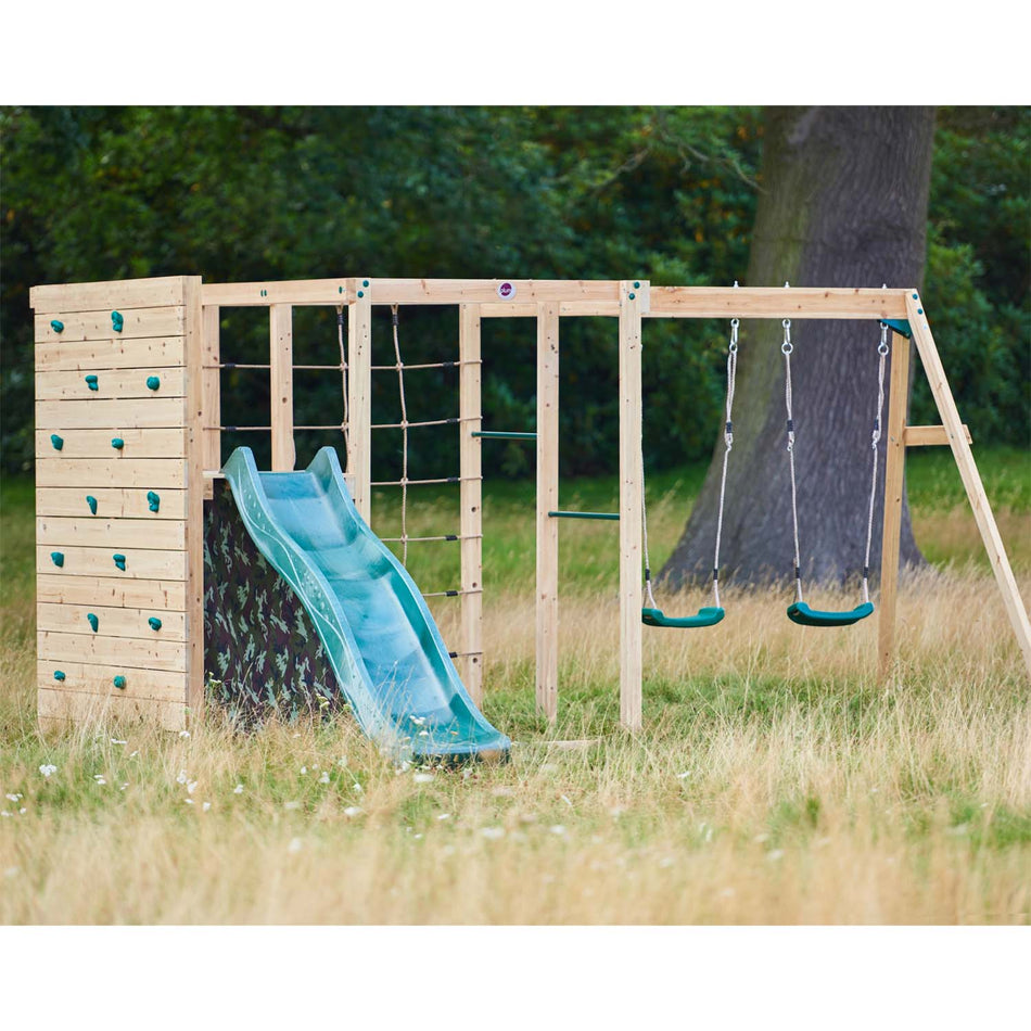 Plum Play's Wooden Climbing Cube with Swing Arm installed in a lawn