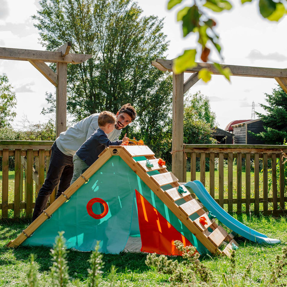 Dad and son playing on the Plum Play's My First Wooden Playcentre