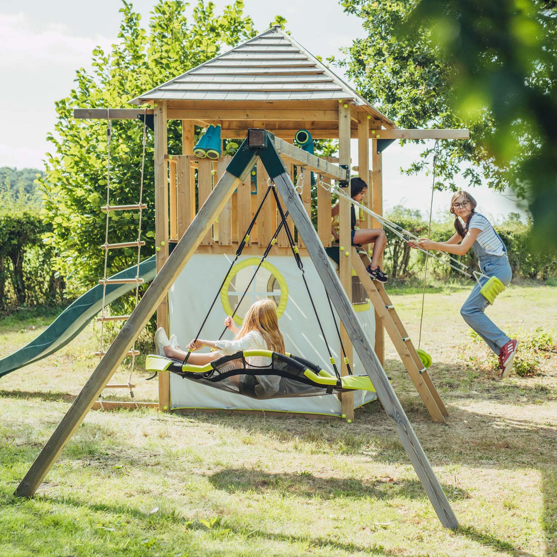 Children playing in Plum Play's Warthog Wooden Playcentre