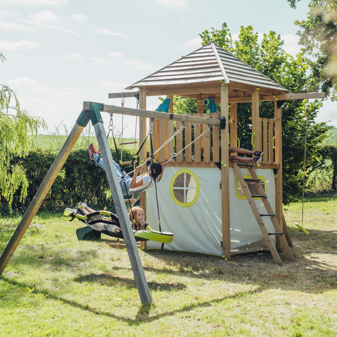 Children playing in Plum Play's Warthog Wooden Playcentre