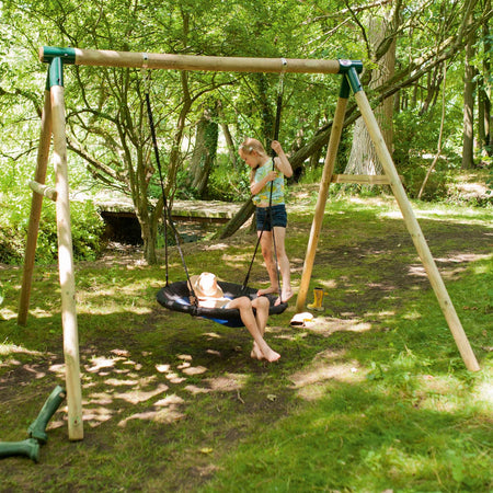 Two children playing on Plum Play's Spider Monkey Wooden Nest Swing Set