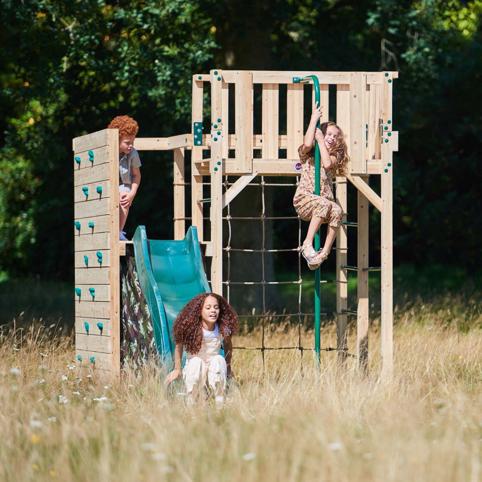 Three children playing in Plum Play's Wooden Climbing Cube XL