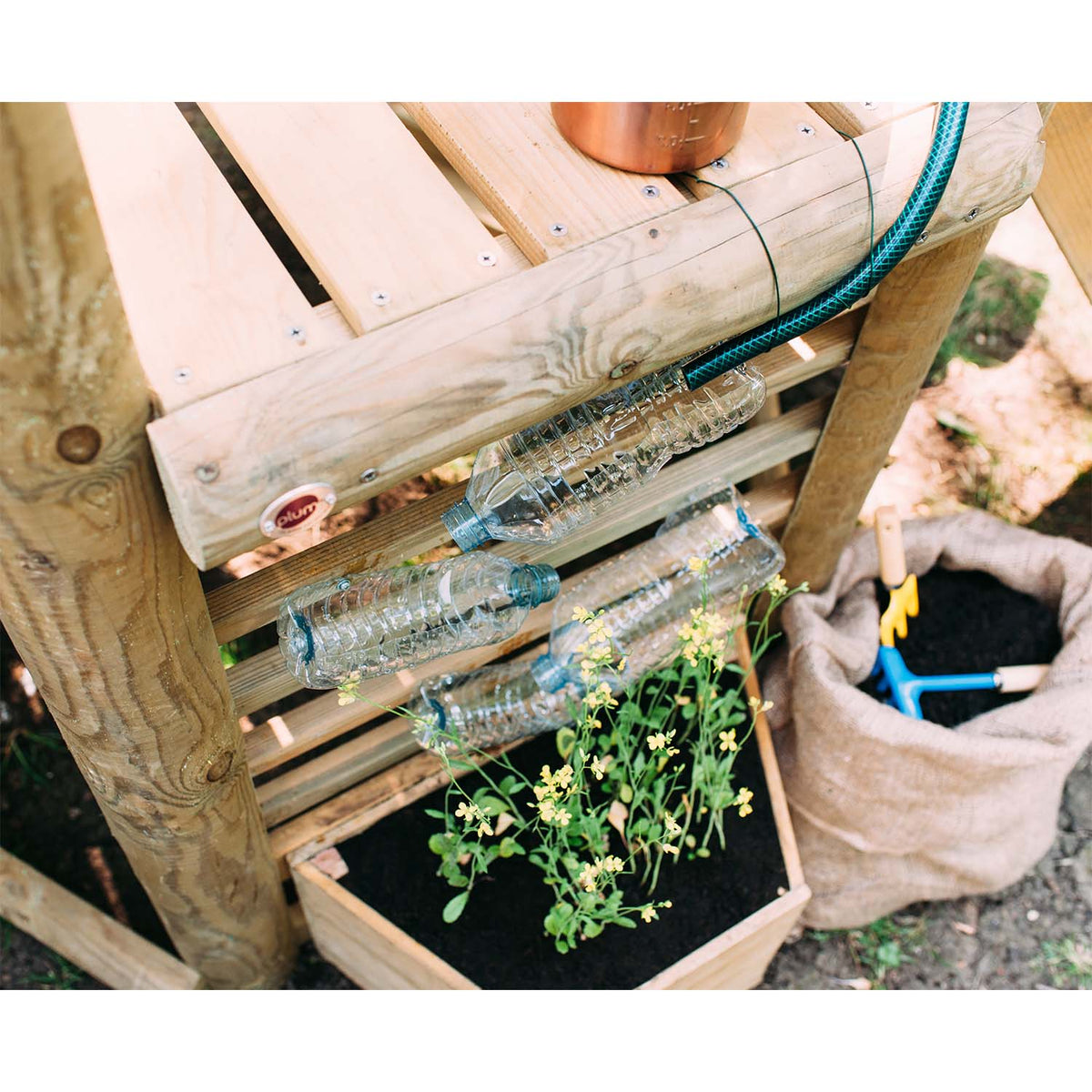 Potten garden with recycled empty bottles in Plum Play's Discovery Woodland Treehouse