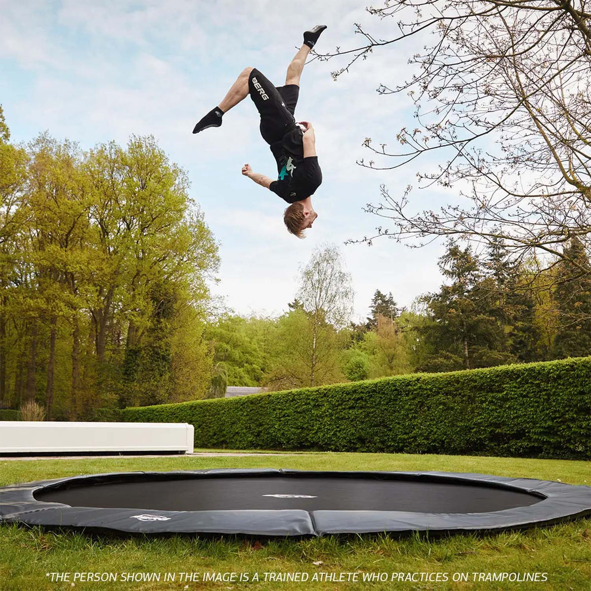 trained athlete bouncing on a BERG SPORTS Elite FlatGround Round Trampoline